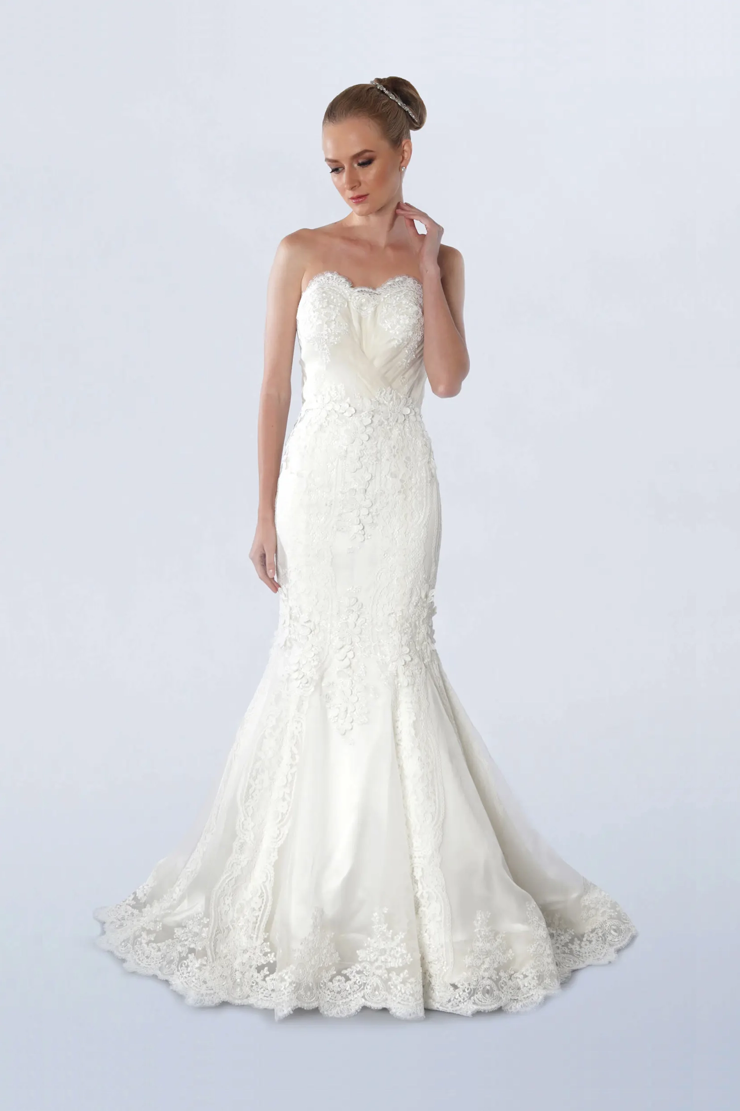 Front view of a woman in a strapless white mermaid gown 1, image 1