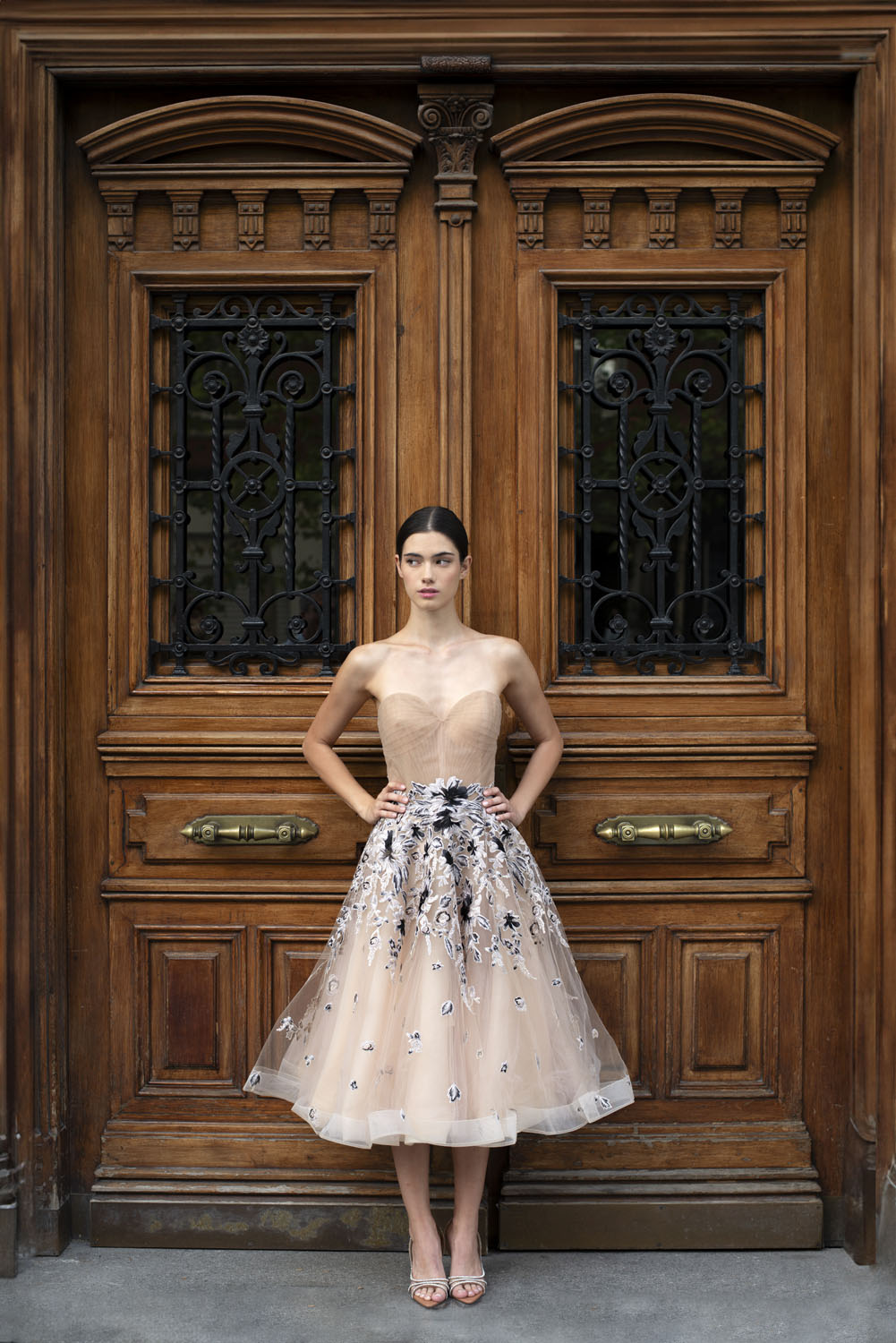 Woman in beige tulle dress with black floral applique. 14, image 1