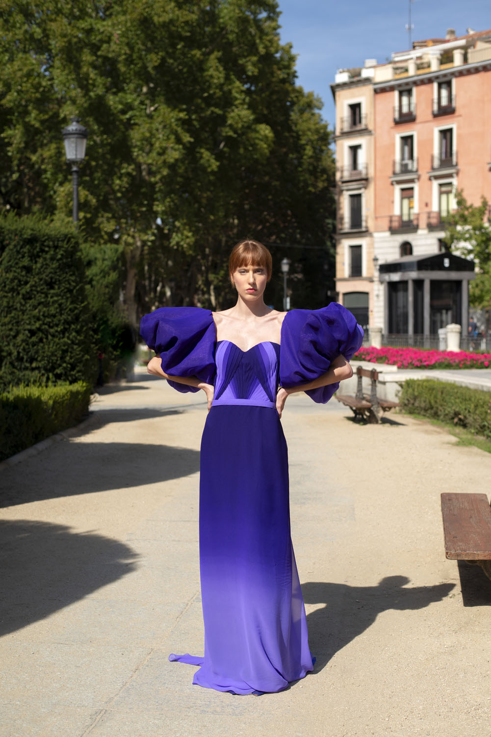 Front view of a woman in a purple gown with puff sleeves. 26, image 1