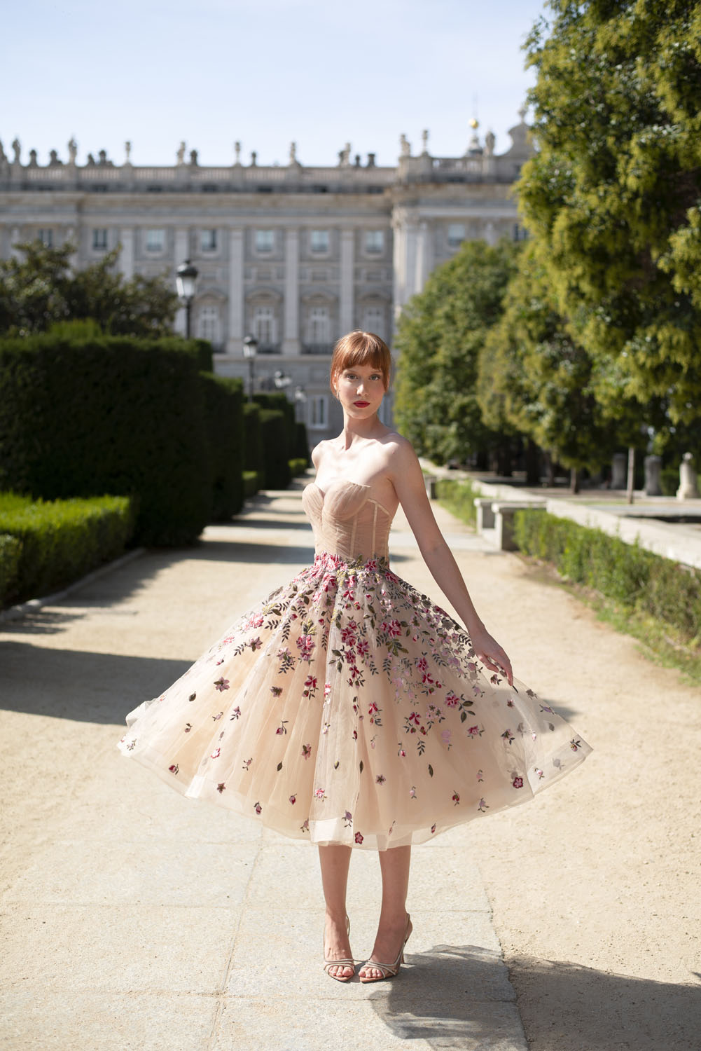 Woman in a beige with red floral applique dress. 28, image 1