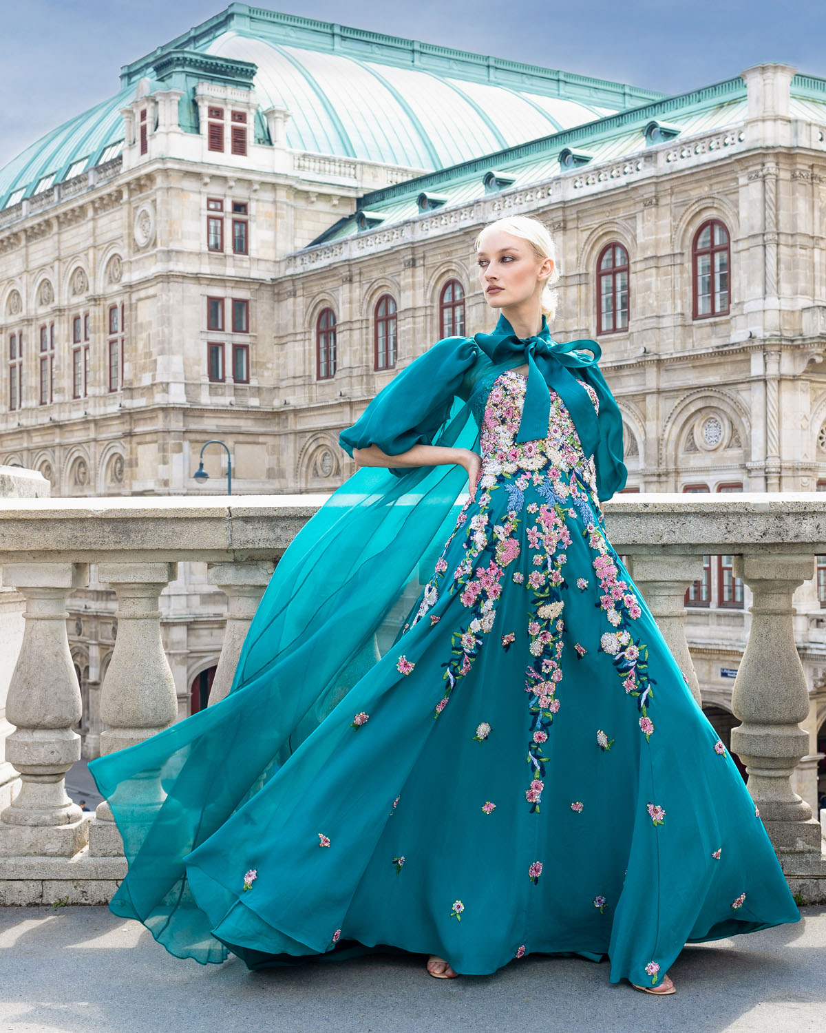 Woman in a turquoise floral ball gown and opera jacket. 3, image 1