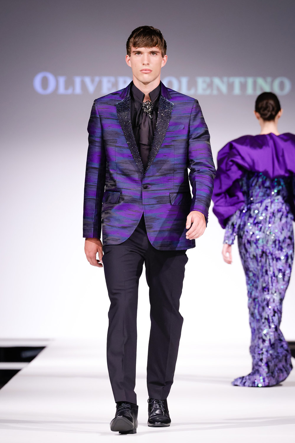Purple print suit jacket, black shirt and black pants