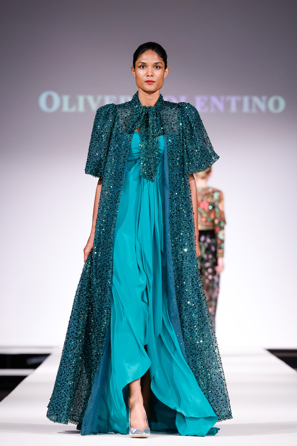 Green flowy gown and sequin opera jacket