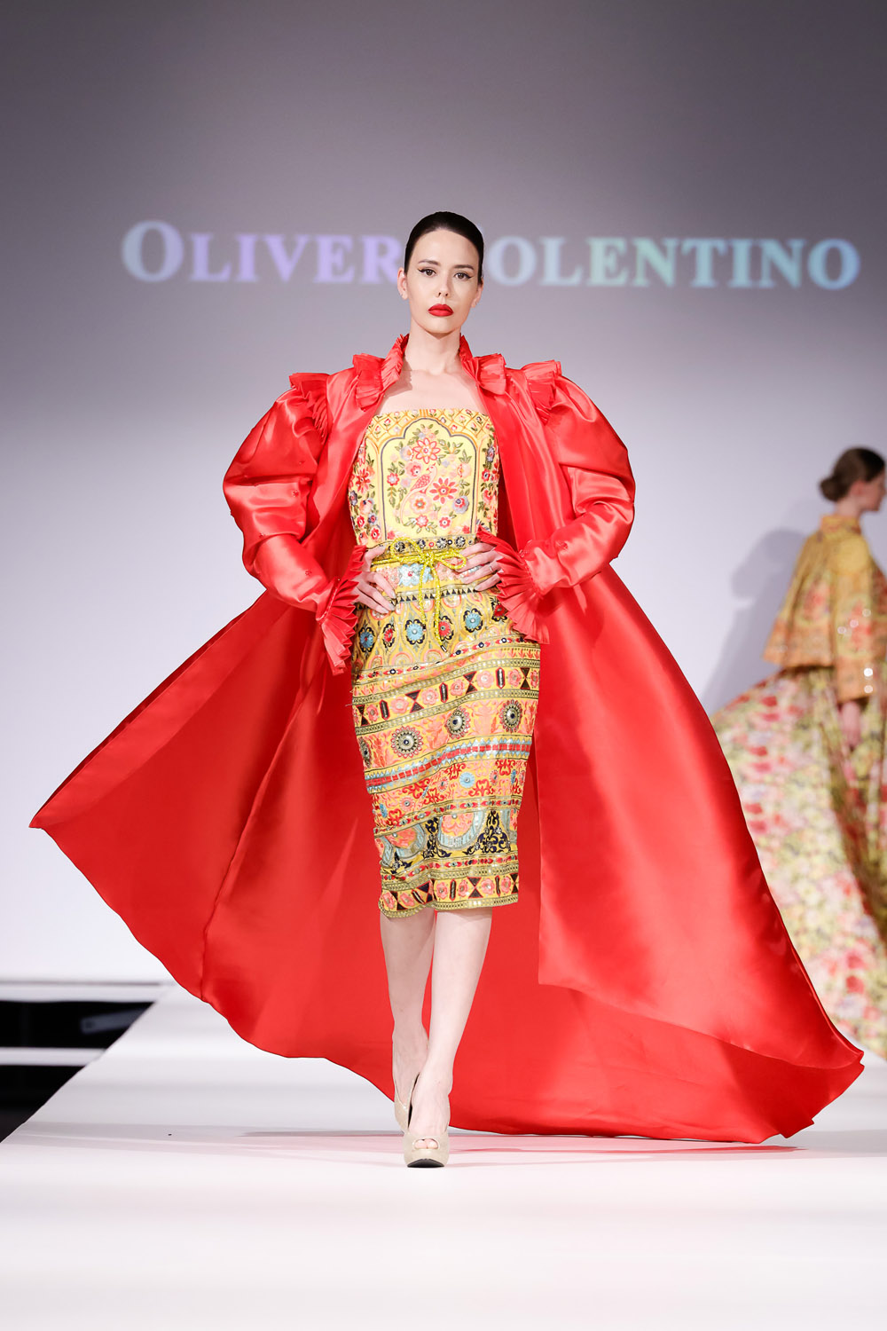 Yellow embroidered cocktail dress, and red opera jacketw