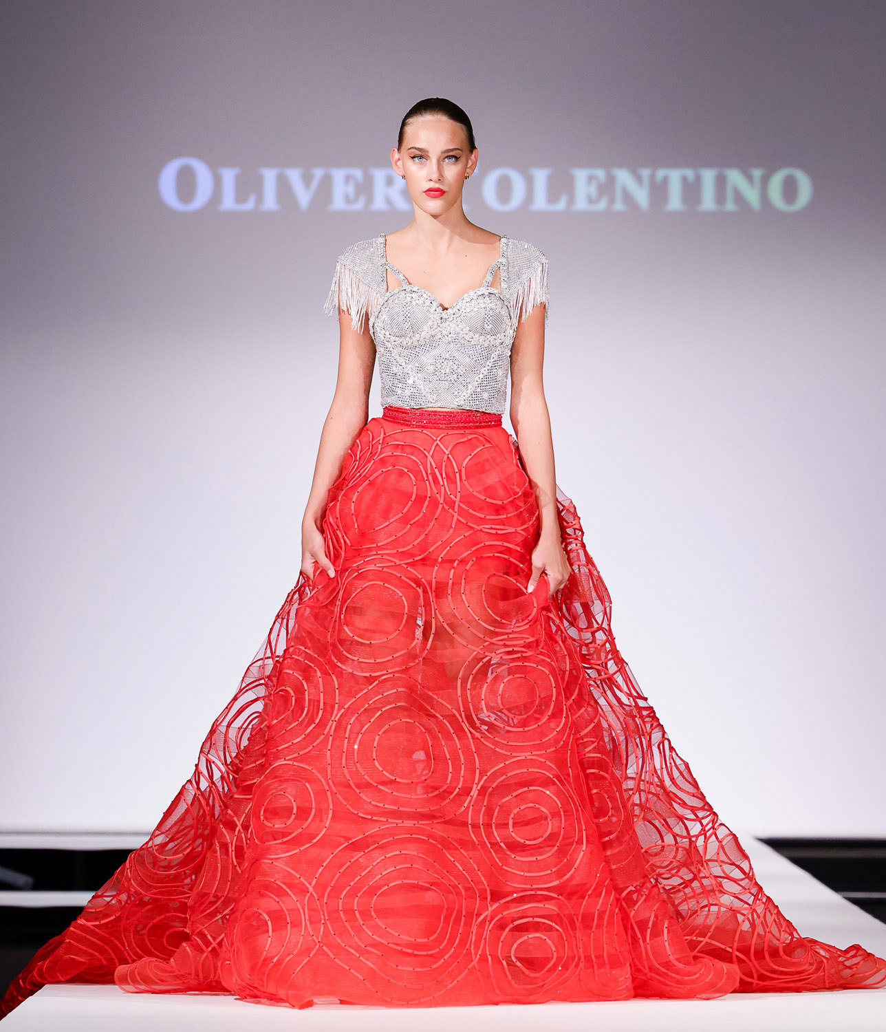Silver embellished top, and red ball skirt