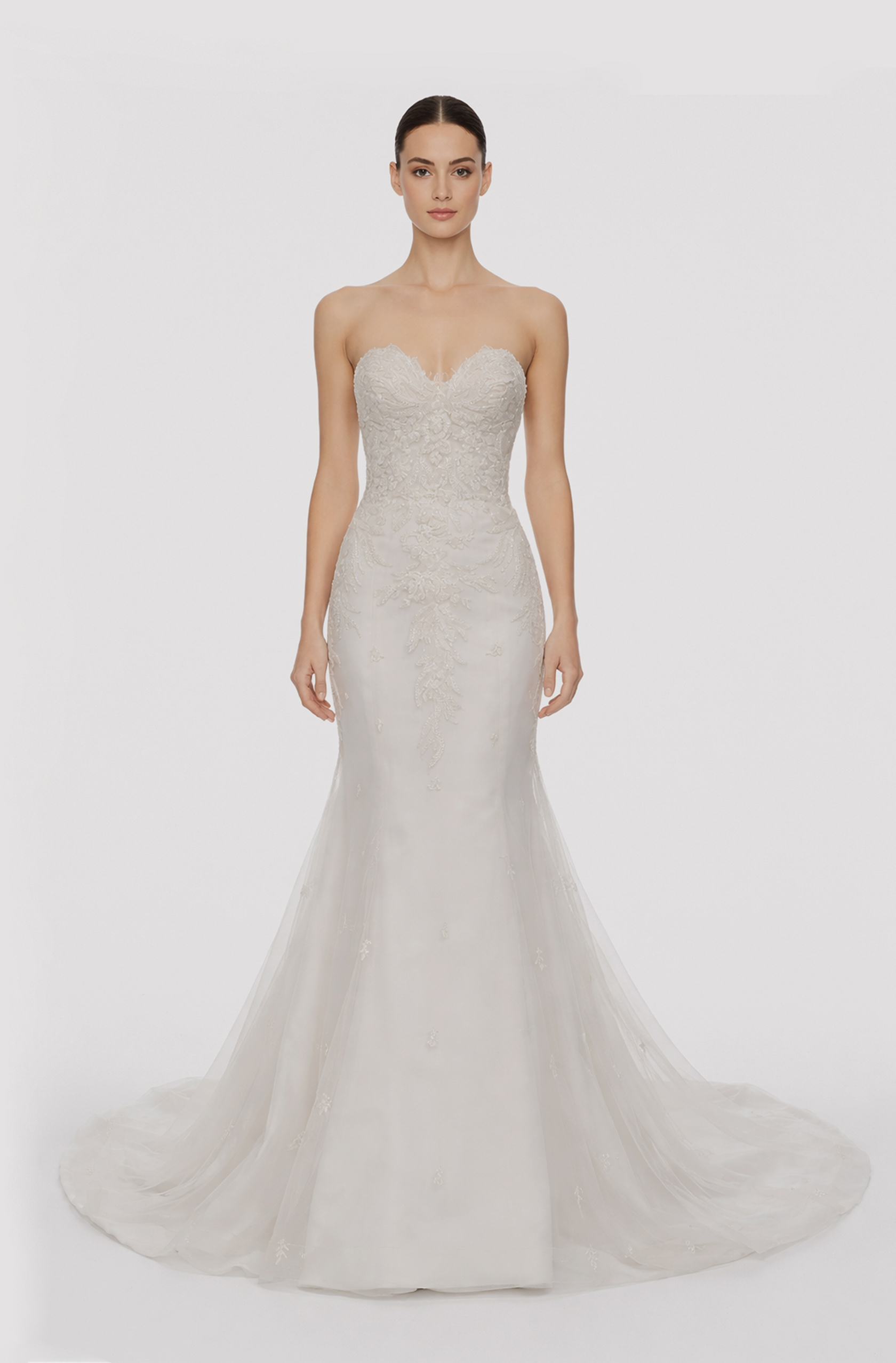 Front view of a woman in an Off-white Fench lace sweetheart mermaid gown with hand-beaded applique bodice 12, image 1