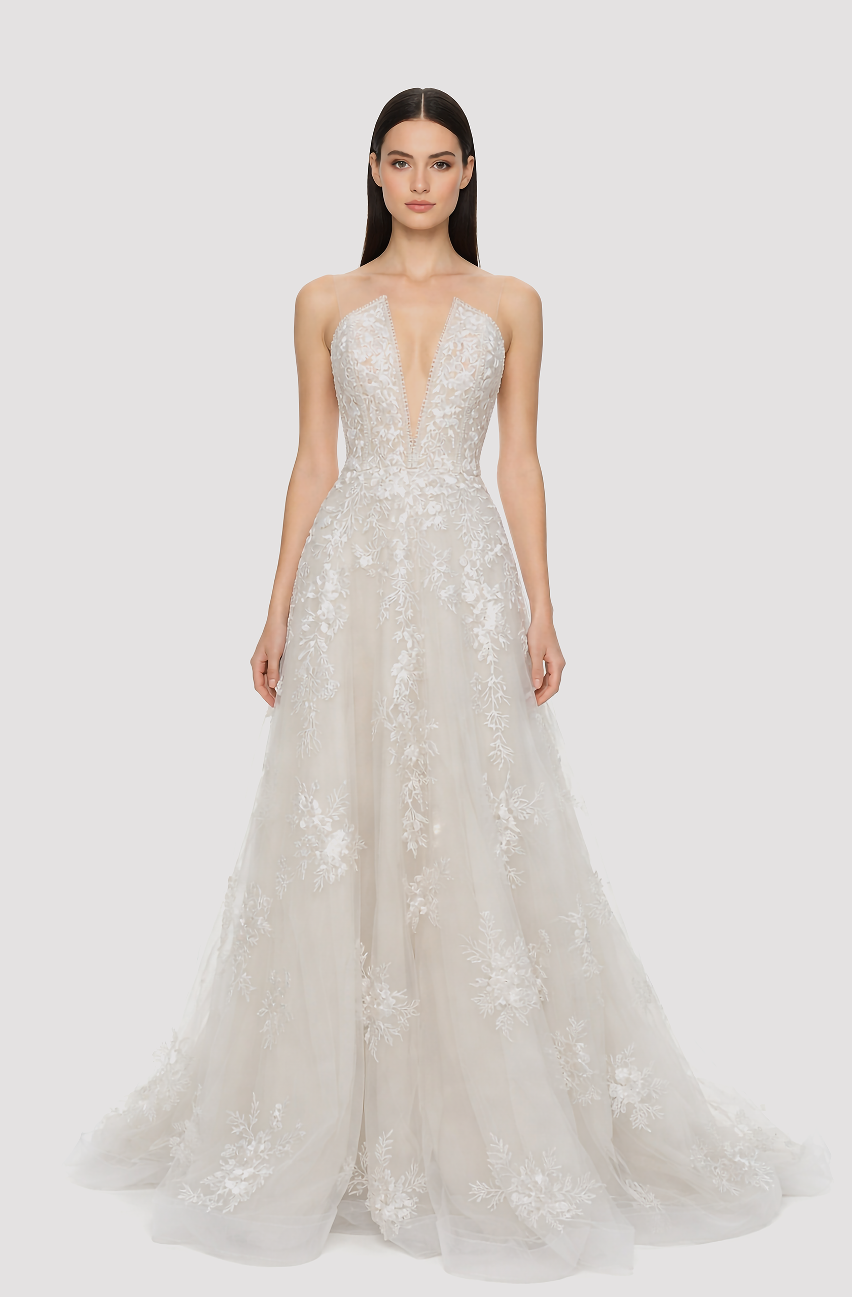 Front view of a woman in an Off-white deep neck tulle ball gown embellished with cascading laces 2, image 1