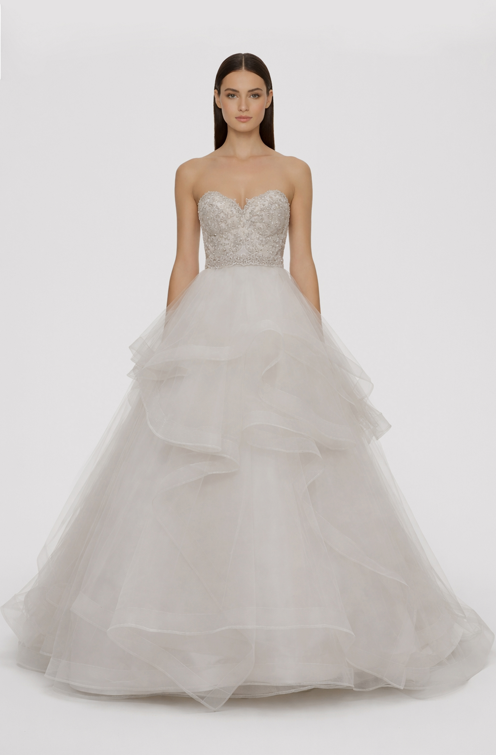 Front view of a woman in an Off-white tulle two-piece ensemble with hand-beaded sweetheart corset and an asymmetrical layered skirt with horsehair 21, image 1