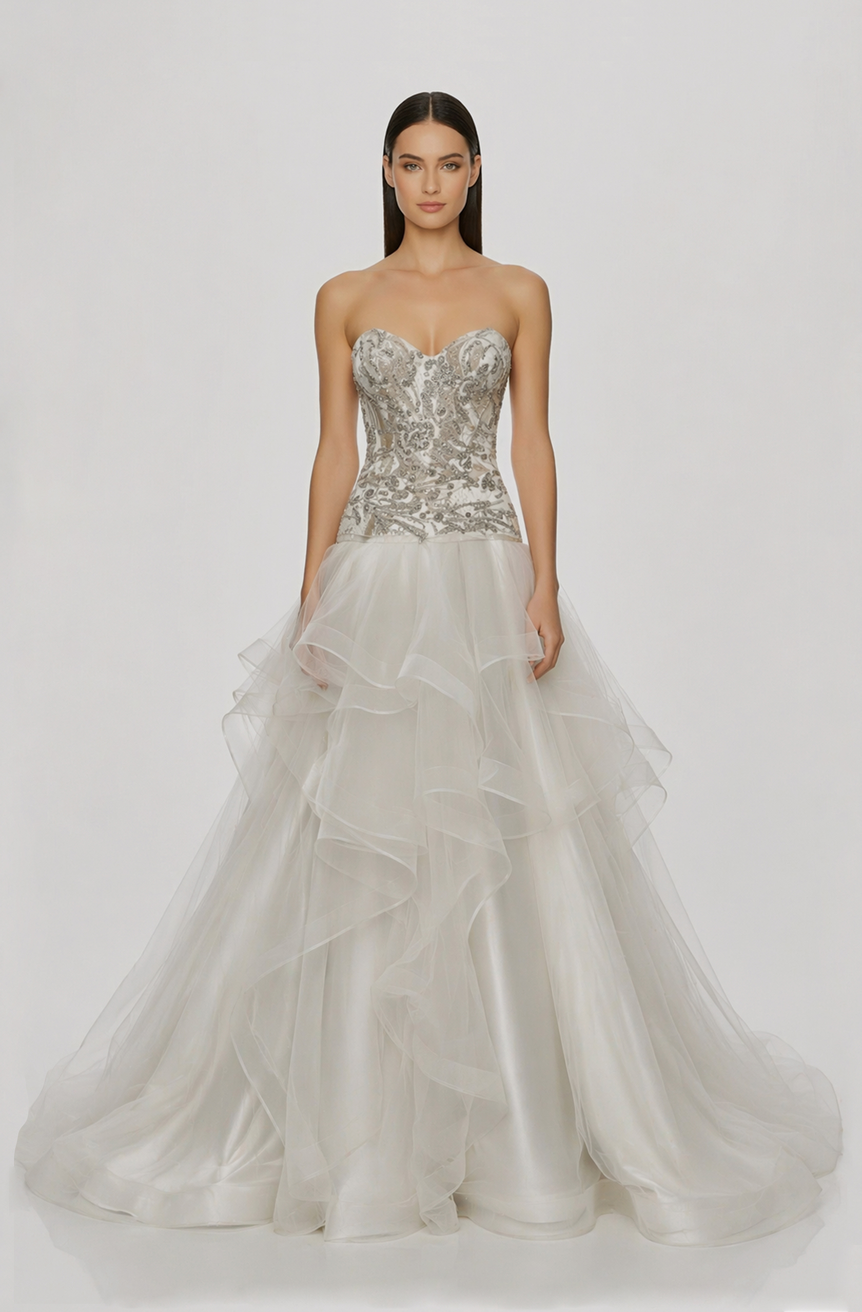 Front view of a woman in an Off-white tulle two-piece ensemble with corset featuring silver hand-beaded embellishment and an asymmetrical layered skirt with horsehair 22, image 1