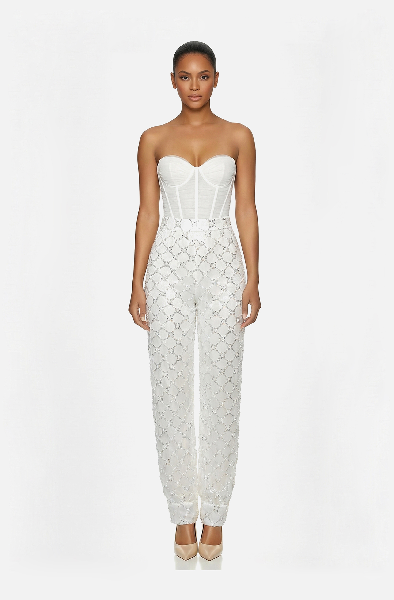 Front view of a woman in an Off-white two-piece ensemble of hand-draped tulle corset with beaded harem pants 41, image 1